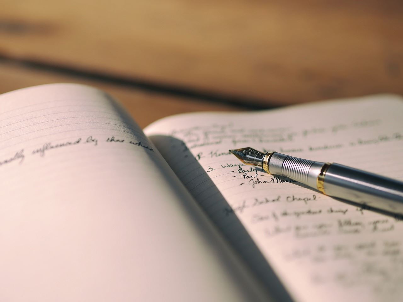 Open notebook with pen